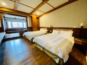 Postel nebo postele na pokoji v ubytování 見晴花園山莊Sunshine Villa