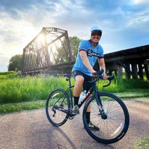 een man op een fiets voor een brug bij Blue House in Sioux Falls