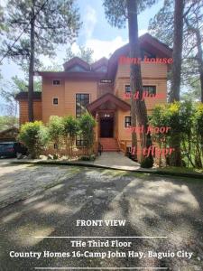 a front view of a house with a driveway at 2BR- 4th Floor Camp John hay For Rent in Baguio