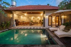 a villa with a swimming pool in front of a house at [Seminyak central] private 3 bedrooms villa with swimming pool in Seminyak