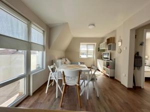 a kitchen and dining room with a table and chairs at Dockview atelier in Burgas +17 photos