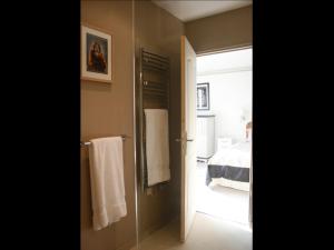a bathroom with a door leading to a bedroom at Guesthouse Kathome in Bondues +26 photos