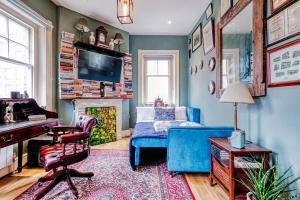 a bedroom with a blue bed and a fireplace at Sunny Corner Apartment in Center of London in London