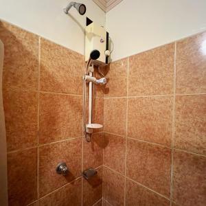 a shower with a shower head in a bathroom at Balayong Pension in Puerto Princesa City