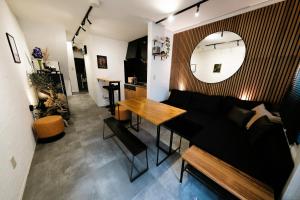 a living room with a couch and a table at Eden House in Tokyo
