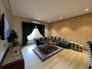 a living room with a couch and a table at 1 Bed Luxurious Apartment at Bahria Heights 5 in Rawalpindi