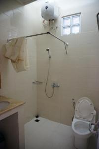 a bathroom with a shower and a toilet at Griya Kayana Inn and Villas in Bogor