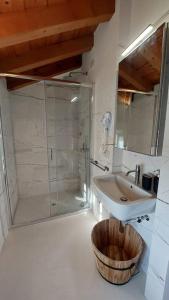 a bathroom with a sink and a shower at Sui Tetti di Valeggio - Holiday Apartment in Valeggio sul Mincio +16 photos