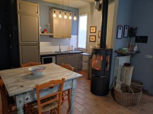 a kitchen with a table and a stove in it at B & B Casolara in San Giovanni