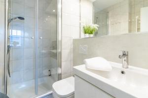 een badkamer met een douche, een toilet en een wastafel bij Ferienwohnung Ebbe in Hooksiel