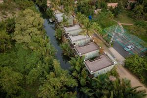 an overhead view of a row of houses next to a river at Ganesha Kampot Resort in Kampot