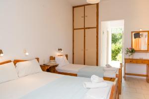 a bedroom with two beds and a window at Kalofonos Studios in Zakynthos
