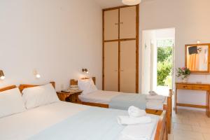 a bedroom with two beds and a window at Kalofonos Studios in Laganas