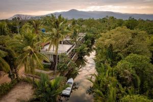 an aerial view of a house in the middle of a river at Ganesha Kampot Resort in Kampot