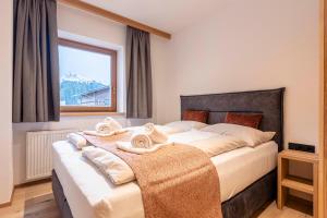 Postel nebo postele na pokoji v ubytování Dorfresort Kitzbühel by ALPS RESORTS