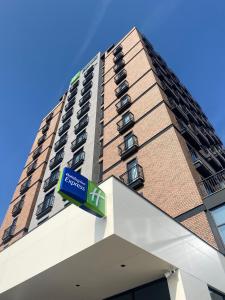 a tall building with a sign in front of it at Holiday Inn Express - Ankara - Airport by IHG in Ankara
