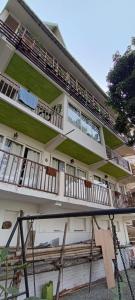 a building with balconies on the side of it at Tito's Homestay in Kalimpong