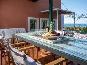 a table with a bowl of fruit and wine glasses at Villa Verde in Malia