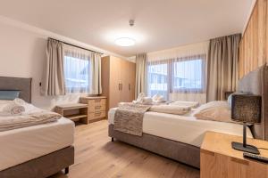 Postel nebo postele na pokoji v ubytování Dorfresort Kitzbühel by ALPS RESORTS
