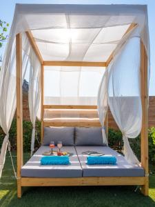 a bed with a canopy in a yard at Villa Verde in Malia