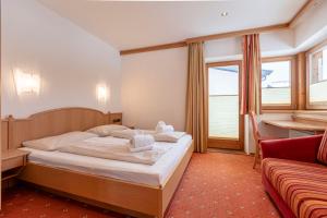 Postel nebo postele na pokoji v ubytování Dorfresort Kitzbühel by ALPS RESORTS
