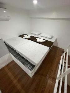 a bedroom with a bed with two objects on it at ARJ Property Rental in Paringao La Union in Bauang