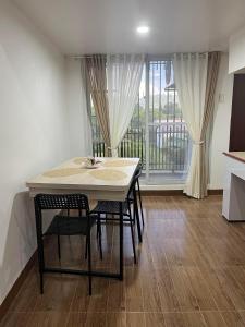 a table and chairs in a kitchen with a window at ARJ Property Rental in Paringao La Union in Bauang