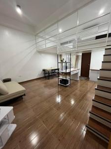 an empty living room with a couch and a staircase at ARJ Property Rental in Paringao La Union in Bauang