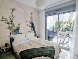 a bedroom with a bed and a large window at A modern villa with pool and sea view in Pilar de la Horadada