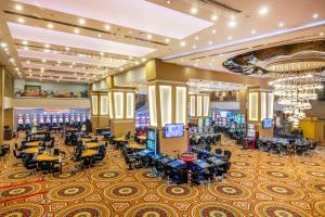 a casino with tables and chairs in a casino at Grand Pasha Lefkosa Hotel & Casino in North Nicosia