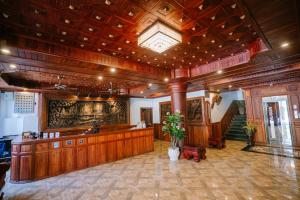 a large room with a lobby with wooden walls and a ceiling at V CROWN HOTEL in Battambang