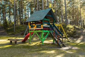 a playground with a slide and a play structure at Kempings Bejas in Babīte