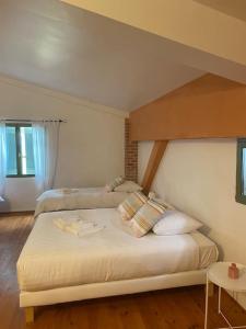 ein Schlafzimmer mit einem großen Bett mit Kissen darauf in der Unterkunft Lauraguel Gîte in Mourvilles-Hautes