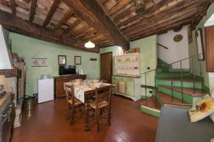 a kitchen with a table and a staircase in a room at Il Mirtillo in Pisa