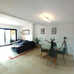 a living room with a couch and a table at Luxury large 2 bedroom Apartment short walk to Villamartin Plaza in Villamartin