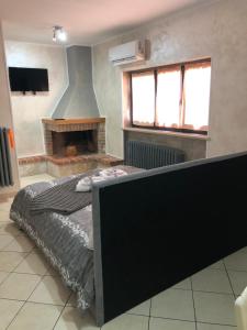 a bedroom with a bed and a fireplace at ALLOGGIO TAMBURRO in Campobasso