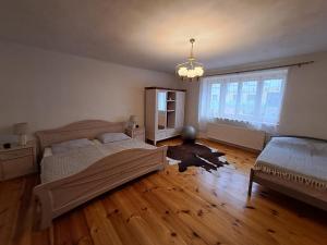 a bedroom with two beds and a large window at Statek Žíšov in Žíšov