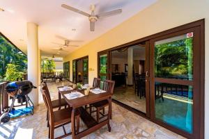 a dining room with a table and a patio at Cozy 3 Bedroom Pool Villa Close to Town - CV3L in Hua Hin
