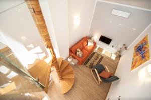an overhead view of a living room with an orange couch at Rooftop Delight with Terrace in Lucca