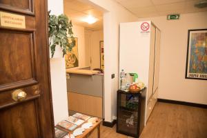 a hallway of a hospital with a table and a door at Le Stanze di Boccadasse in Genova