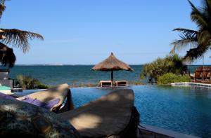 a swimming pool with a view of the ocean at Villas do Indico in Vilanculos