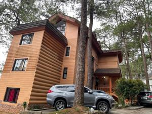 a house with a car parked in front of it at 2nd Floor- 3BR camp John Hay Unit For Rent in Baguio