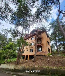 a building on a hill with trees in front of it at 2nd Floor- 3BR camp John Hay Unit For Rent in Baguio