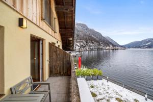 a balcony of a building with a view of a lake at Hallstatt Lakeside Top 5 - Zimmer mit Balkon in Hallstatt