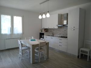 a kitchen with a table and chairs in a room at Villa CLE in Capoliveri