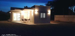 a small house with a table in front of it at night at Villa CLE in Capoliveri
