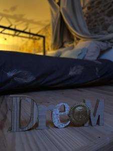 a close up of the word ion on a bed at Love House "L'évasion Secrète" in Rivesaltes