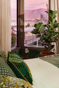 a bedroom with a bed and a window with a view at Villa Balfour in Eilat