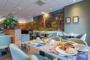 a dining room with a table with food on it at Amrâth Hotel Alkmaar in Alkmaar