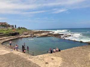 a group of people in a swimming pool on the beach at Uvongo Sea Scapes Holiday Apartment in Margate
